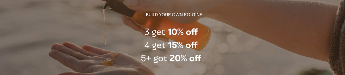 A close-up of a hand holding a small amber bottle over another hand, with overlaid text reading 'BUILD YOUR OWN ROUTINE' and discount percentages for 3, 4, 5, and 6 bottles.